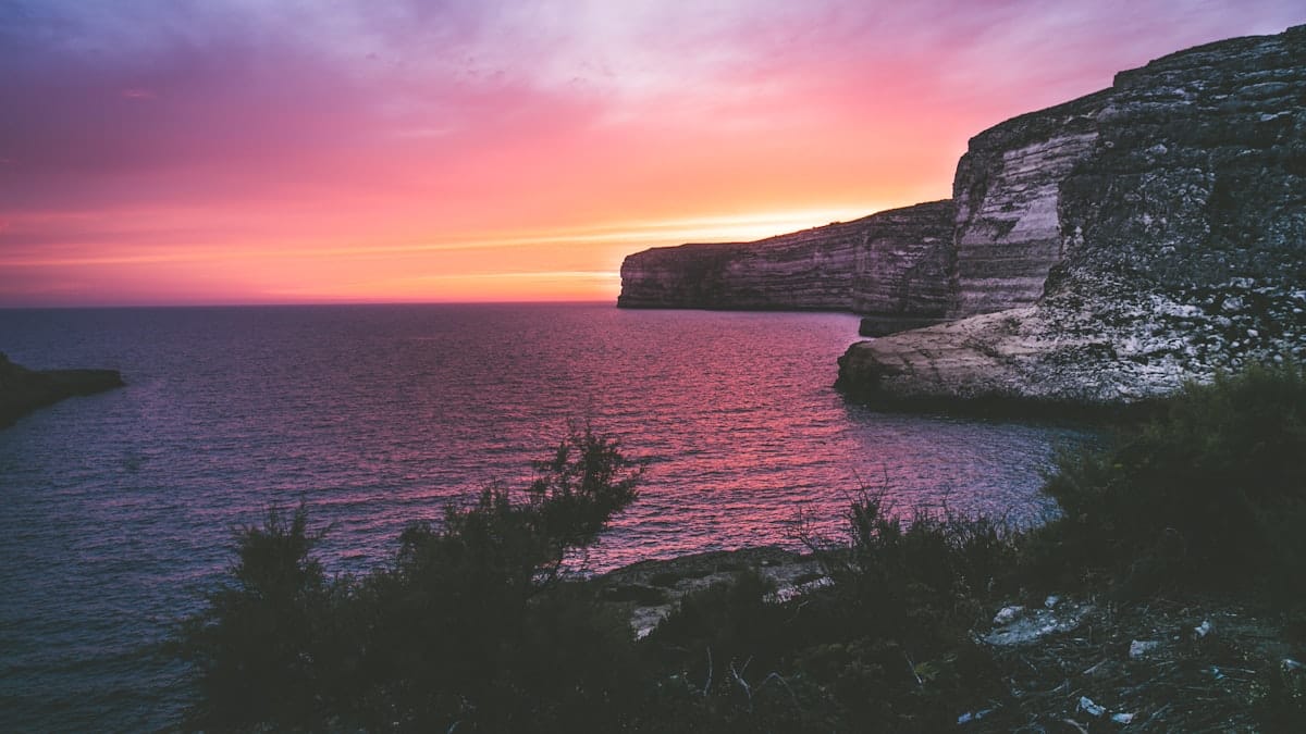 Dramatic sunset over the limestone cliffs of Gozo, Malta